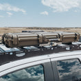 Load image into Gallery viewer, Durable olive green hard case with reinforced latches mounted on black roof rack of white vehicle.
