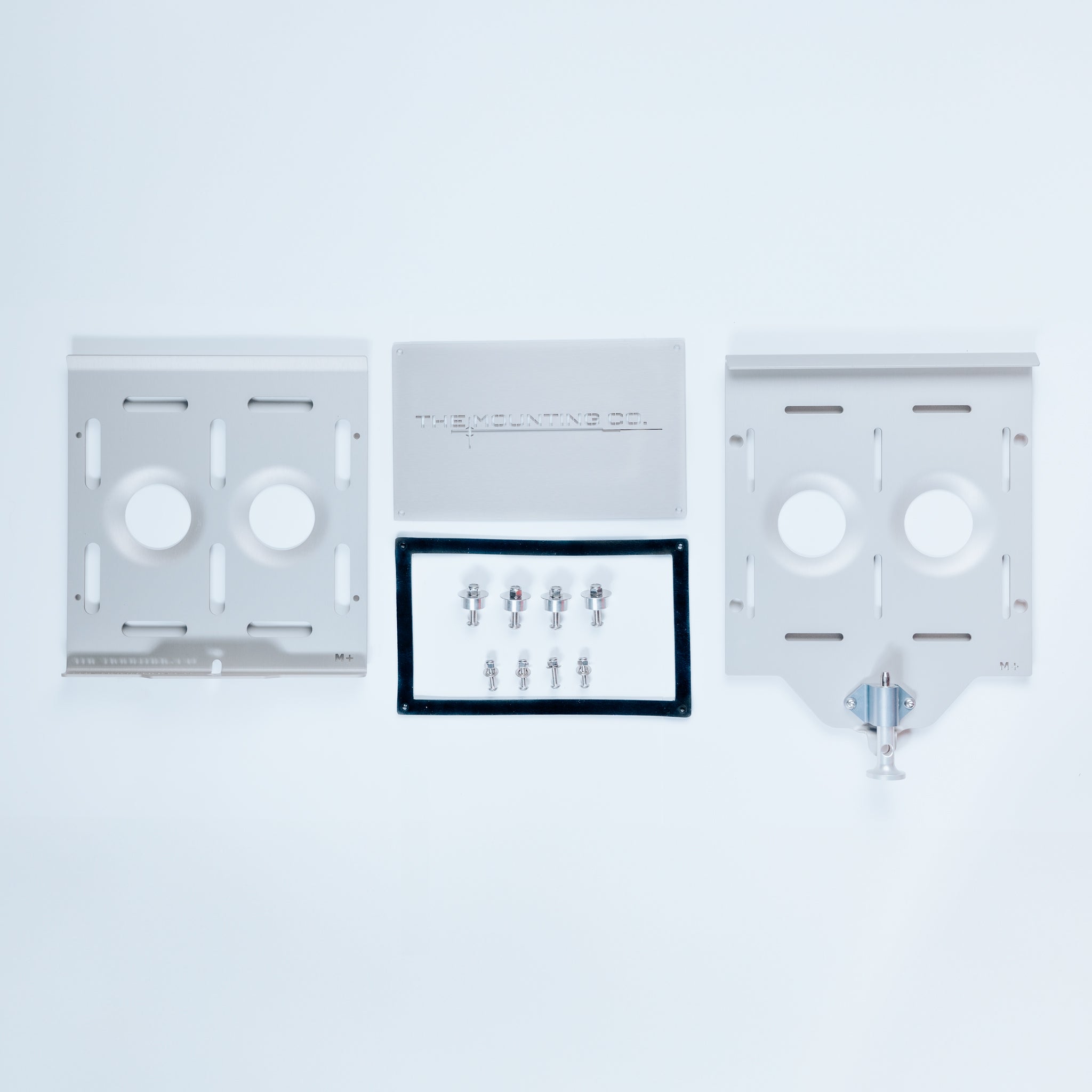 Silver aluminum Medium+ Mount kit with two mounting plates, hardware, and quick-release clamp on white background.