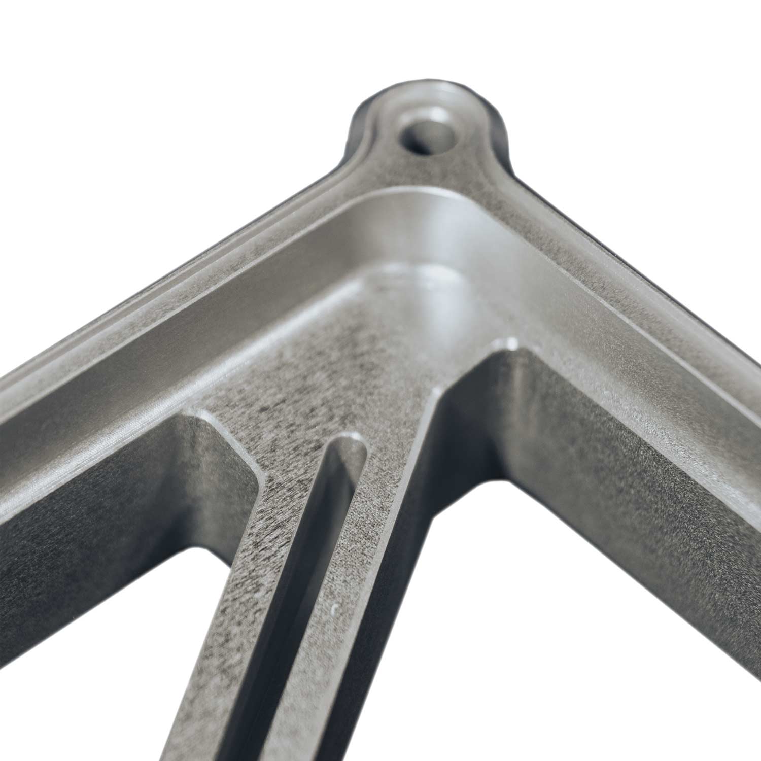 Close-up of silver metal Starlink Mini Mount with smooth and textured surfaces and a mounting hole.