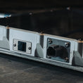 Load image into Gallery viewer, Metal Starlink Mini mount with power and data ports on a dark surface.
