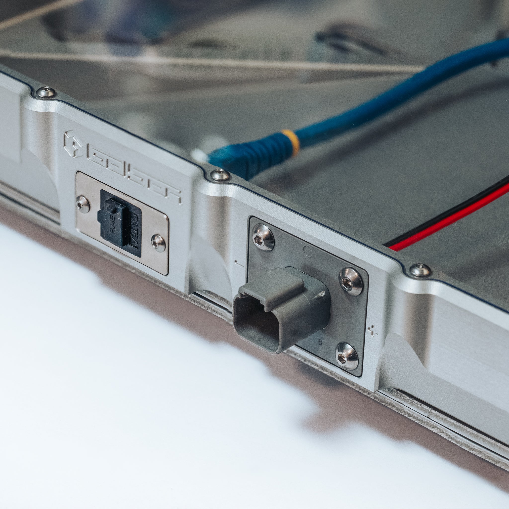 Metal Starlink Mini Mount with Ethernet port and blue cable attached.