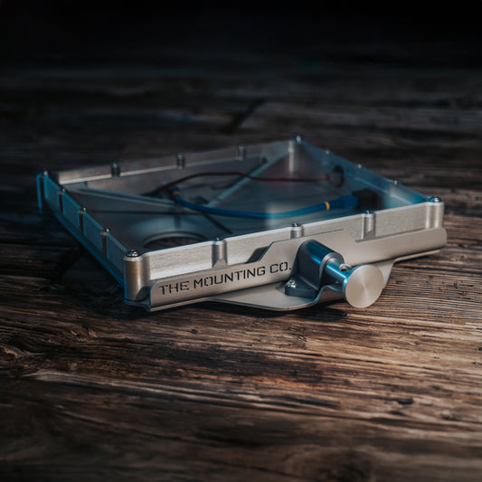 Metallic Starlink Mini Mount with adjustable clamp on dark wooden surface.