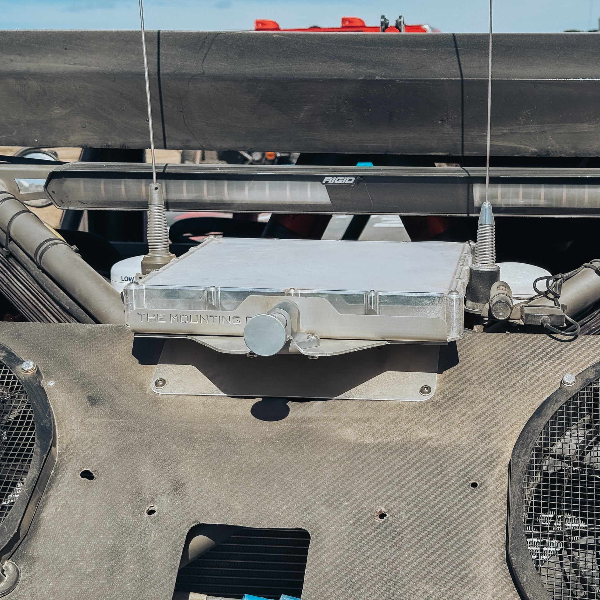 Compact metal Starlink Mini mount attached to a vehicle with visible antennas and cables.