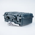 Load image into Gallery viewer, Black hard-shell protective case with reinforced edges and secure latches, angled view.
