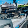 Load image into Gallery viewer, Black aluminum TMC Starlink quick-release mount installed on off-road vehicle roof rack.
