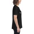 Load image into Gallery viewer, Black relaxed-fit women's t-shirt with short sleeves and white logo text on the chest, side view.
